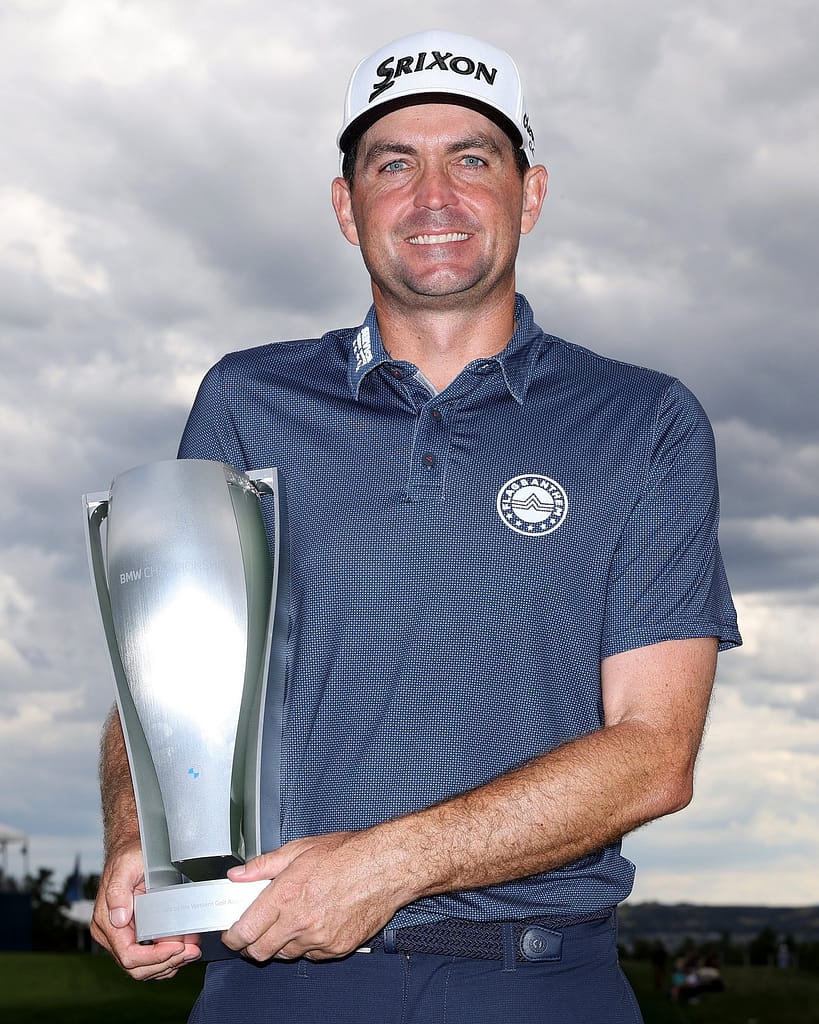 Keegan holding BMW championship trophy